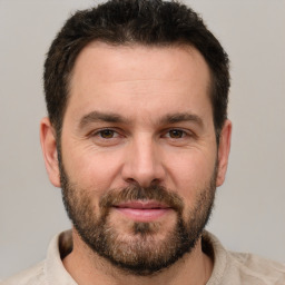 Joyful white adult male with short  brown hair and brown eyes