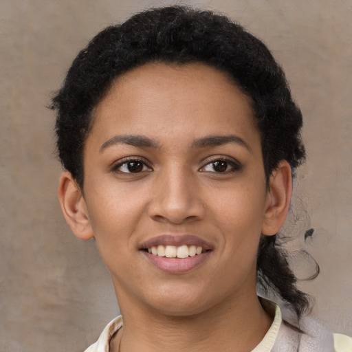 Joyful latino young-adult female with short  black hair and brown eyes