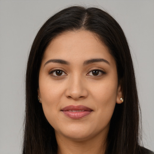 Joyful latino young-adult female with long  brown hair and brown eyes