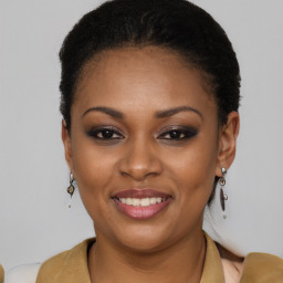 Joyful black young-adult female with short  brown hair and brown eyes