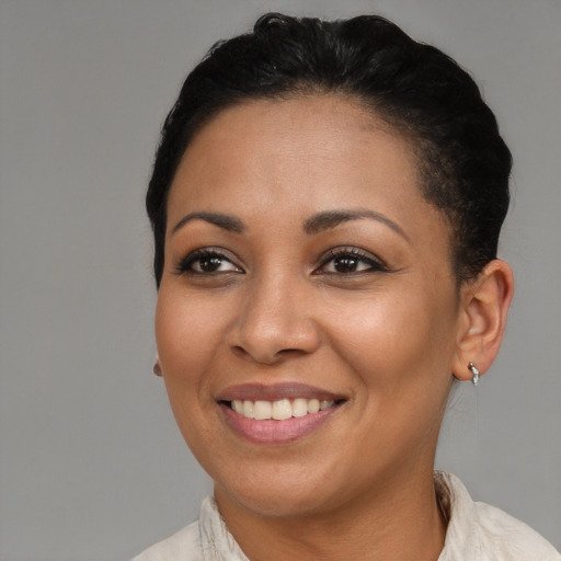 Joyful latino adult female with short  brown hair and brown eyes