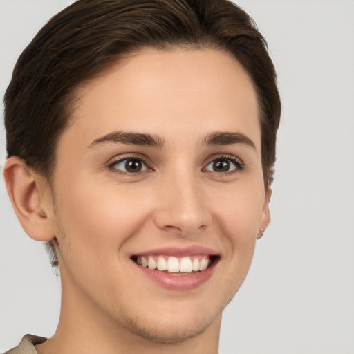 Joyful white young-adult female with short  brown hair and brown eyes