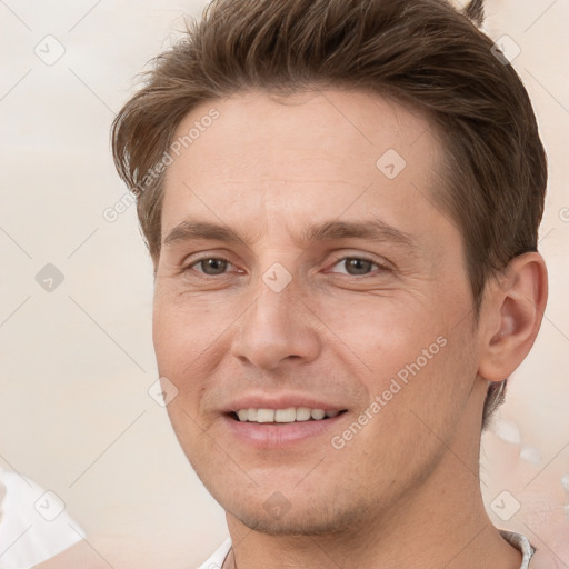 Joyful white adult male with short  brown hair and brown eyes