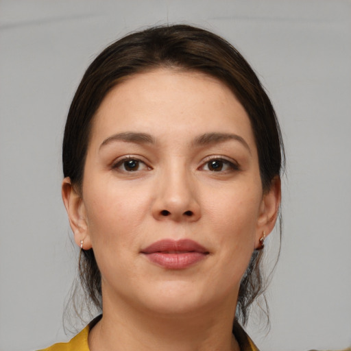 Joyful white young-adult female with medium  brown hair and brown eyes