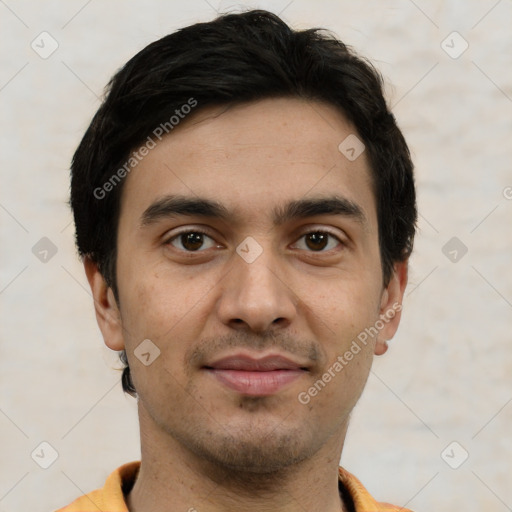 Joyful white young-adult male with short  black hair and brown eyes