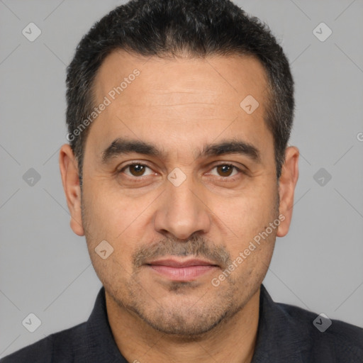 Joyful white adult male with short  black hair and brown eyes