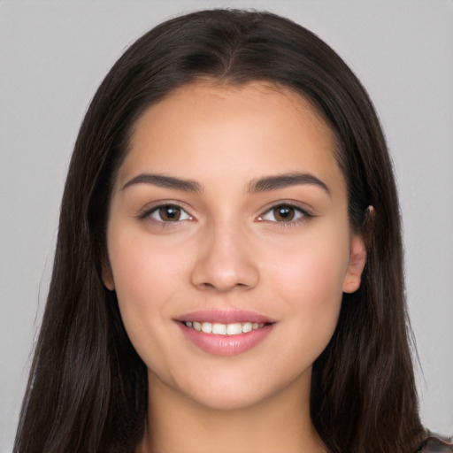 Joyful white young-adult female with long  brown hair and brown eyes