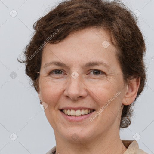 Joyful white adult female with short  brown hair and grey eyes