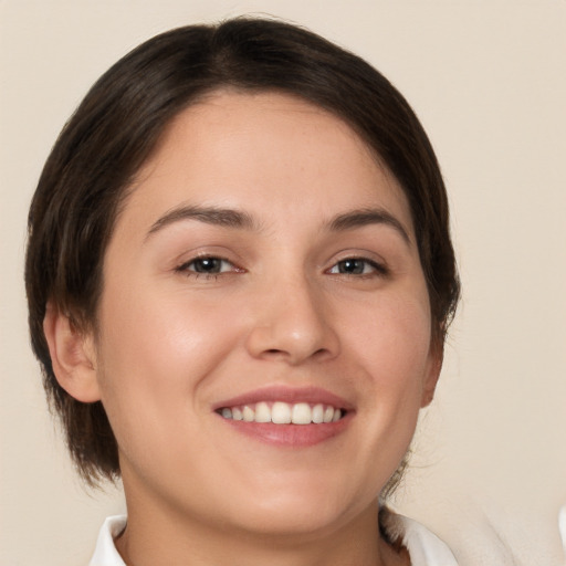 Joyful white young-adult female with medium  brown hair and brown eyes