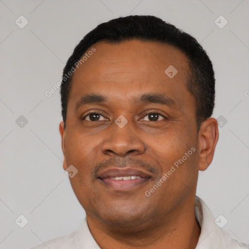 Joyful black young-adult male with short  black hair and brown eyes