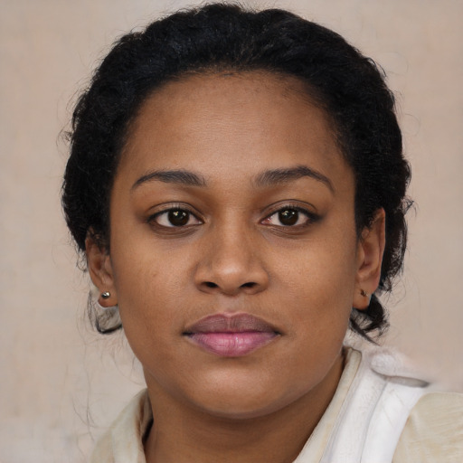 Joyful black young-adult female with medium  brown hair and brown eyes