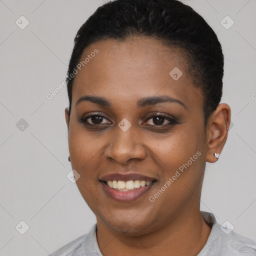 Joyful black young-adult female with short  black hair and brown eyes