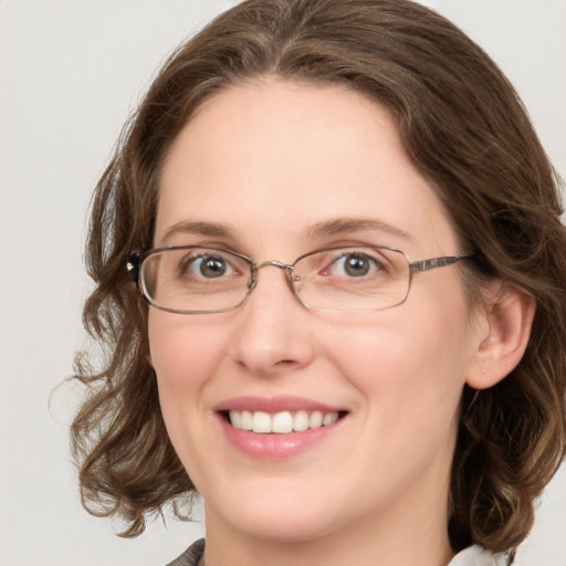 Joyful white young-adult female with medium  brown hair and green eyes