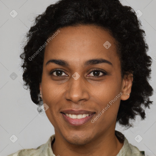 Joyful black adult female with short  black hair and brown eyes