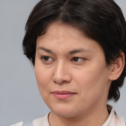 Joyful white adult female with medium  brown hair and brown eyes