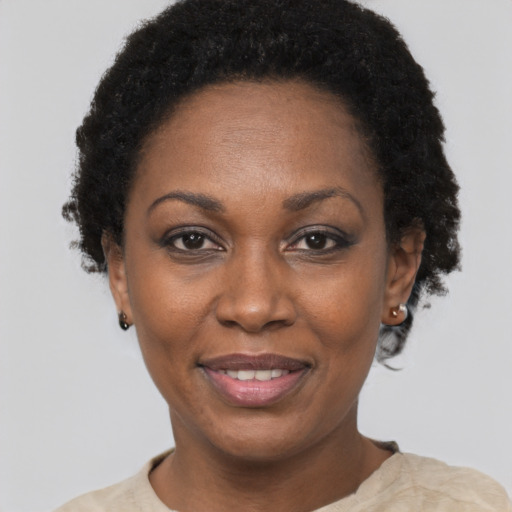 Joyful black adult female with short  black hair and brown eyes