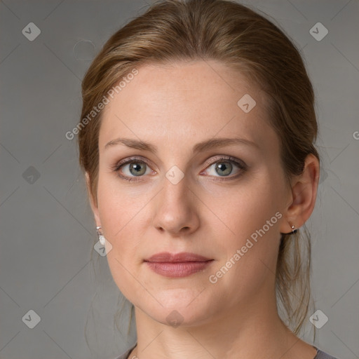 Joyful white young-adult female with medium  brown hair and grey eyes