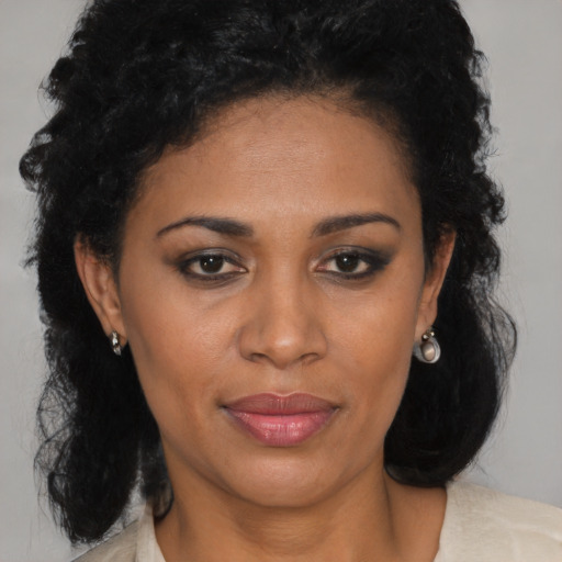 Joyful black adult female with medium  brown hair and brown eyes