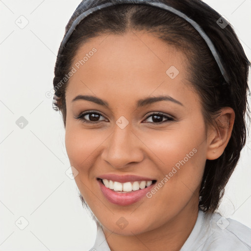 Joyful latino young-adult female with long  brown hair and brown eyes