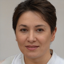 Joyful white adult female with short  brown hair and brown eyes