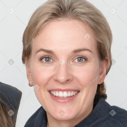 Joyful white adult female with medium  brown hair and blue eyes