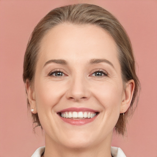 Joyful white young-adult female with medium  brown hair and grey eyes