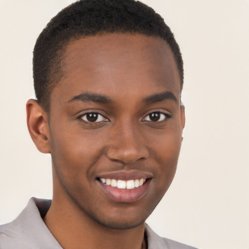 Joyful black young-adult male with short  brown hair and brown eyes