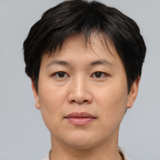 Joyful asian adult female with short  brown hair and brown eyes