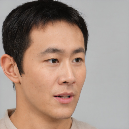 Neutral asian young-adult male with short  brown hair and brown eyes