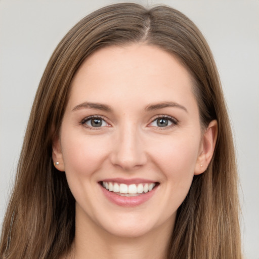 Joyful white young-adult female with long  brown hair and grey eyes