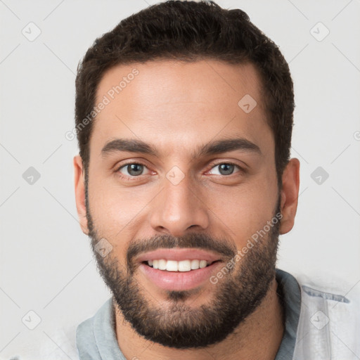 Joyful white young-adult male with short  brown hair and brown eyes