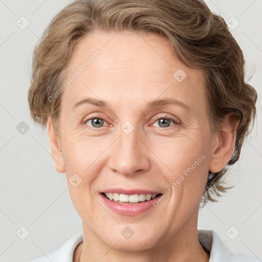 Joyful white adult female with short  brown hair and grey eyes