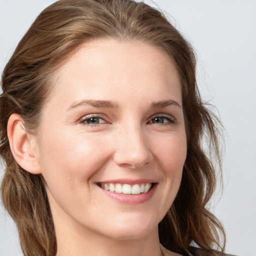 Joyful white young-adult female with long  brown hair and grey eyes