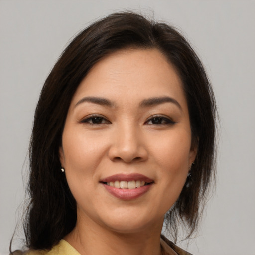 Joyful latino young-adult female with medium  brown hair and brown eyes