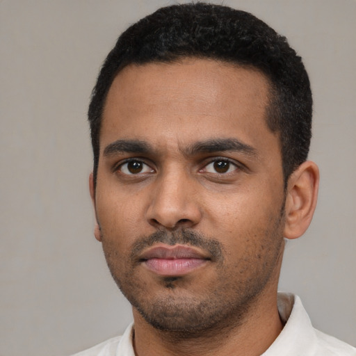 Neutral latino young-adult male with short  black hair and brown eyes