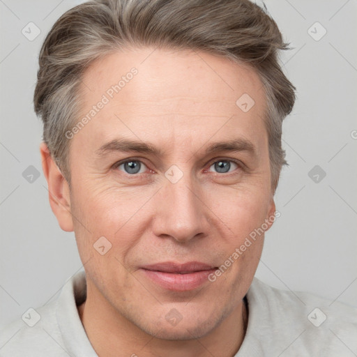 Joyful white adult male with short  brown hair and grey eyes