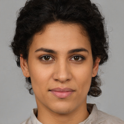 Joyful latino young-adult female with medium  brown hair and brown eyes