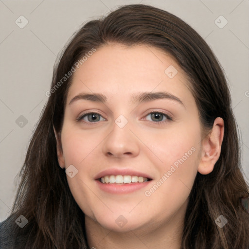 Joyful white young-adult female with long  brown hair and grey eyes