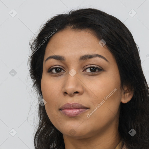 Joyful latino young-adult female with long  brown hair and brown eyes