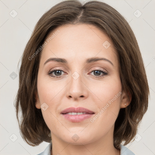 Joyful white young-adult female with medium  brown hair and green eyes