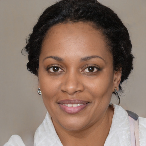 Joyful black young-adult female with medium  brown hair and brown eyes