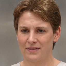 Joyful white adult female with short  brown hair and grey eyes