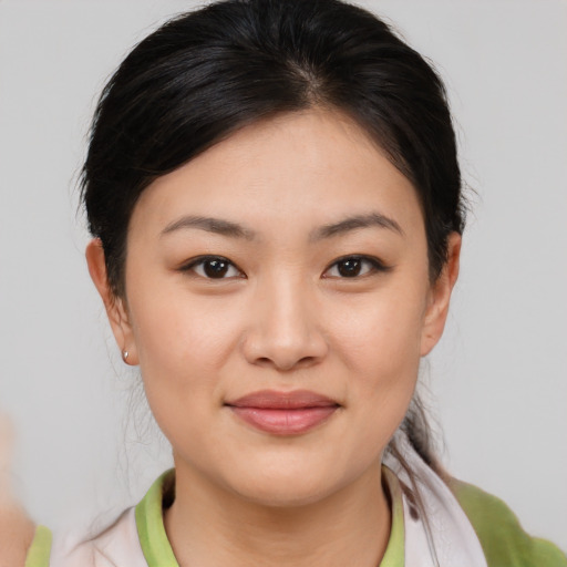 Joyful asian young-adult female with medium  brown hair and brown eyes