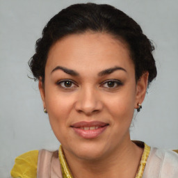 Joyful latino young-adult female with short  brown hair and brown eyes