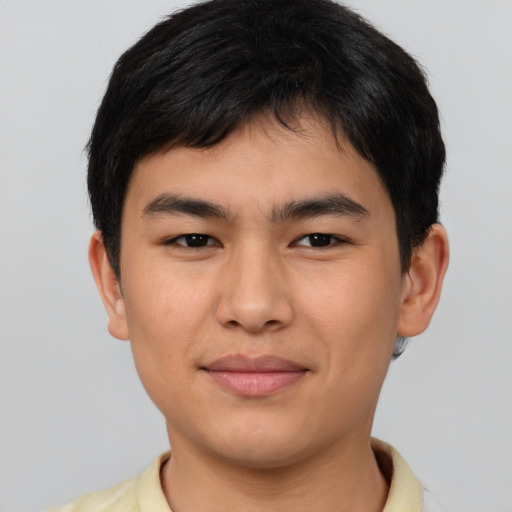 Joyful asian young-adult male with short  brown hair and brown eyes