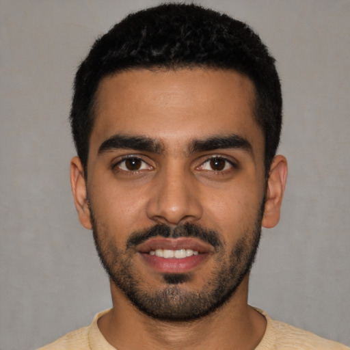 Joyful latino young-adult male with short  black hair and brown eyes