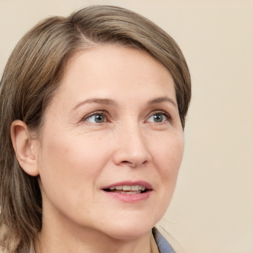 Joyful white adult female with medium  brown hair and brown eyes