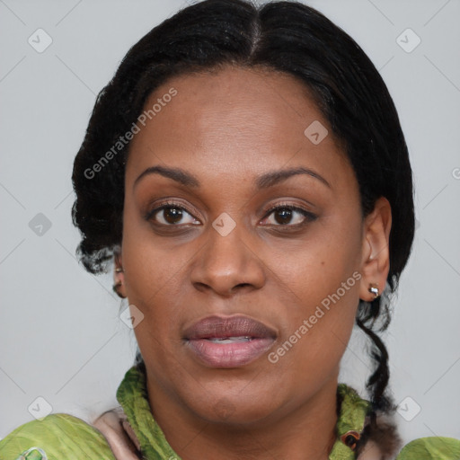 Joyful black adult female with medium  brown hair and brown eyes