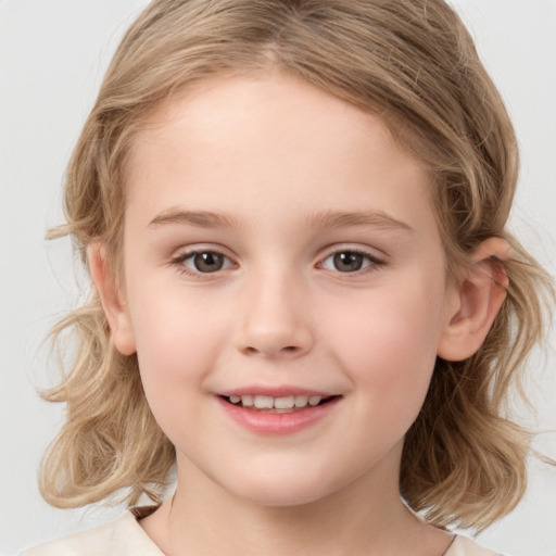 Joyful white child female with medium  brown hair and brown eyes