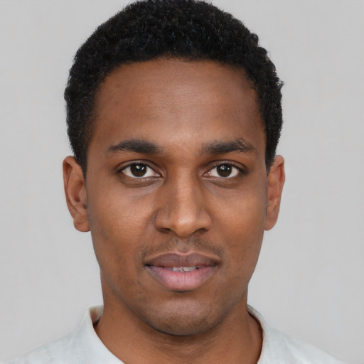 Joyful black young-adult male with short  black hair and brown eyes